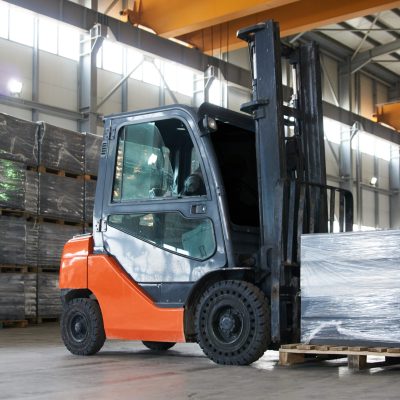 Working Forklift in warehouse. Forklift loader pallet stacker truck equipment at warehouse