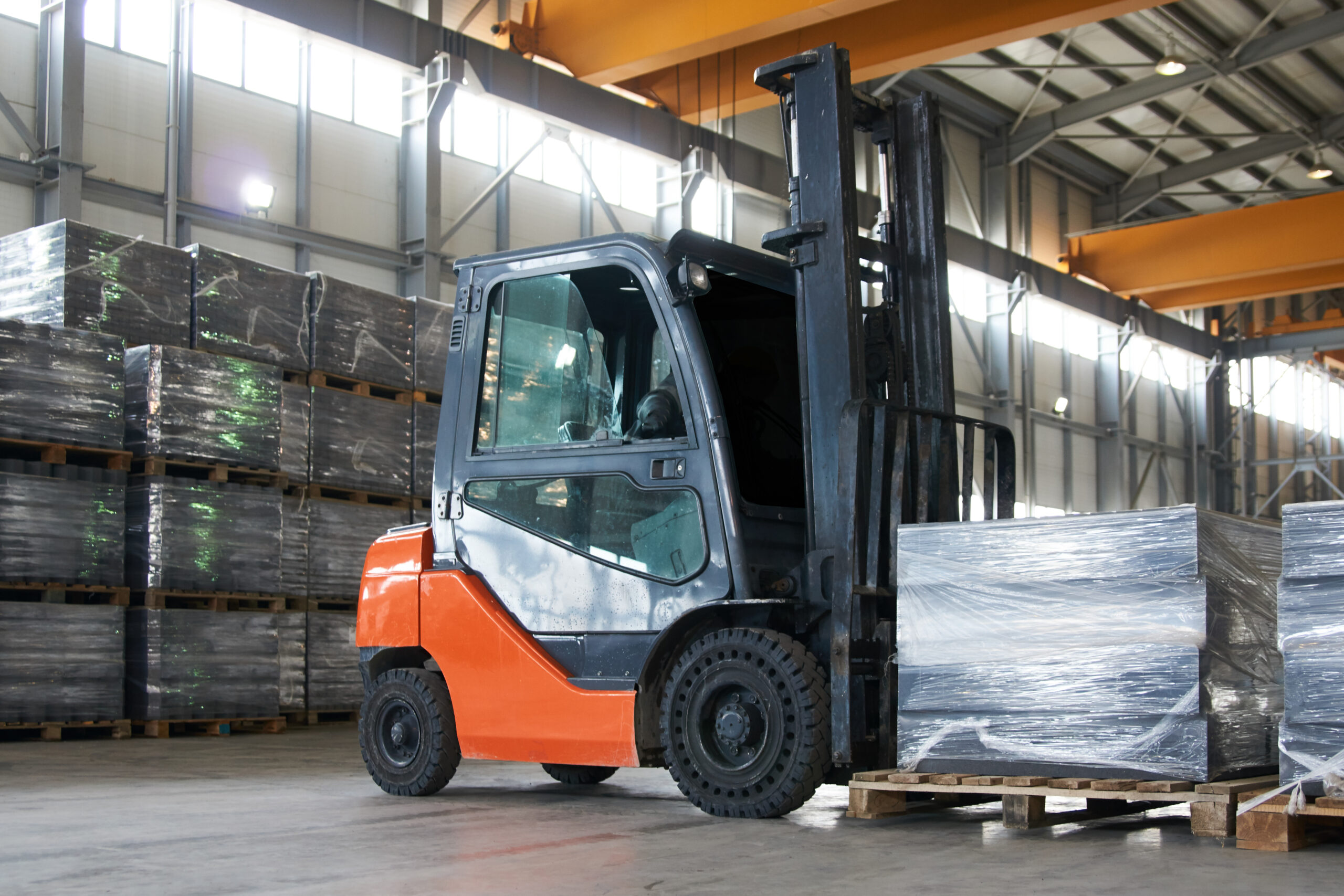 Working Forklift in warehouse. Forklift loader pallet stacker truck equipment at warehouse